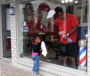 Future Scuba Diver Vanessa Cleaning Windows at Merlot's Barbershop