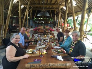 Laura, Mark, Ann Coad, Cheryl and Rich sitting down to eat after flying around the world.